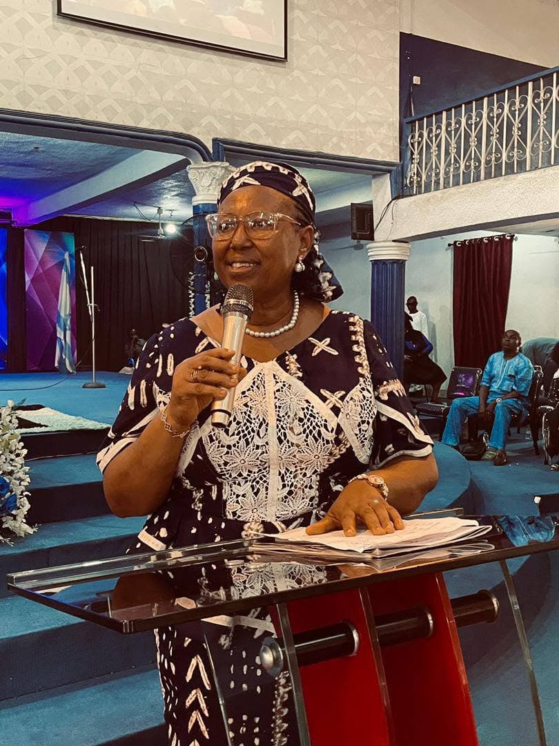 A woman ministering at the pulpit during the anniversary service