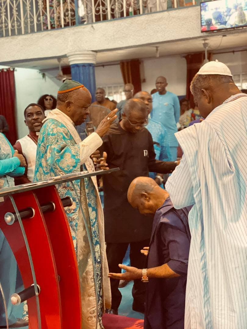 Ministers praying together during the anniversary service