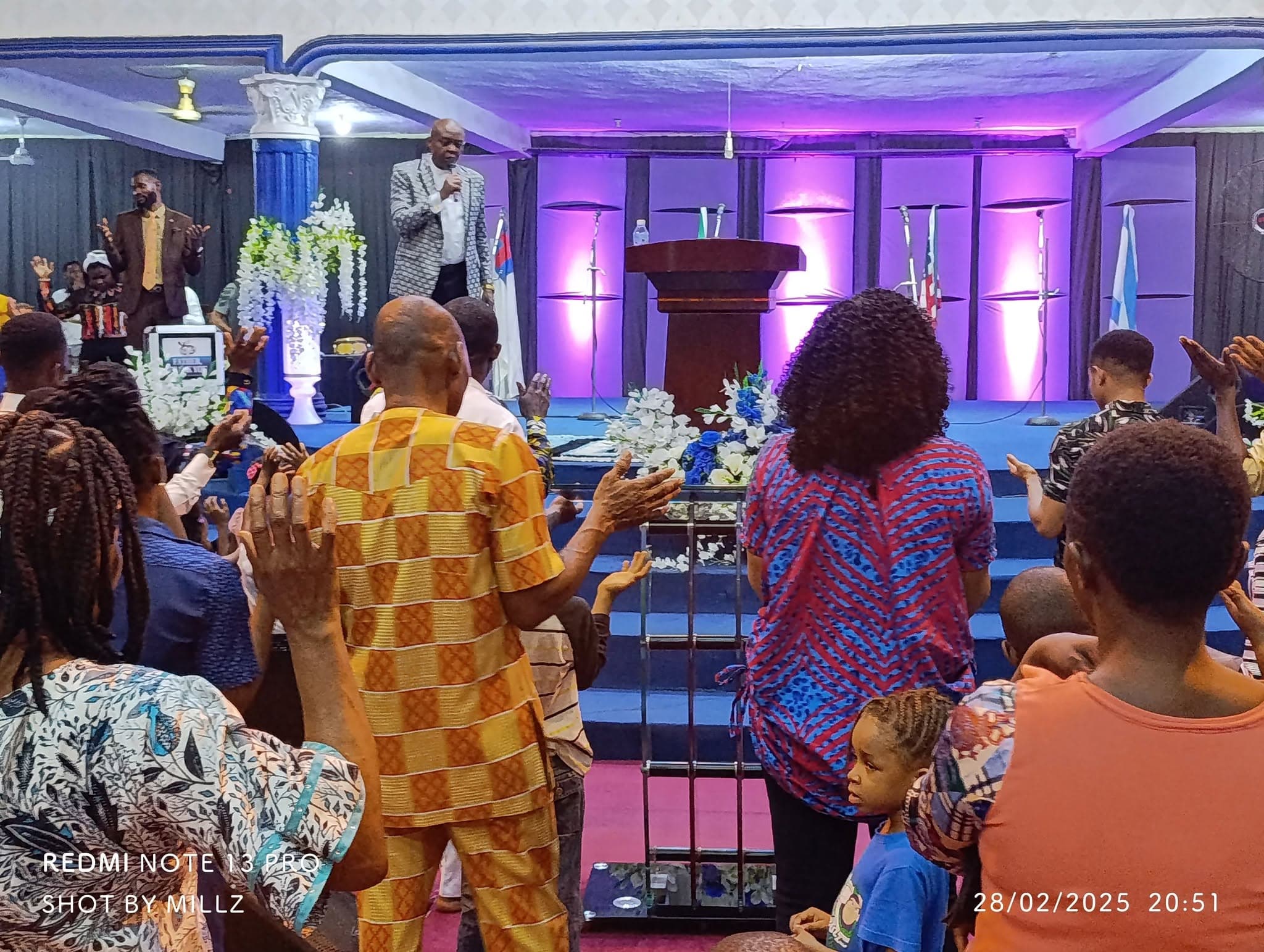 The congregation worshipping before the pulpit