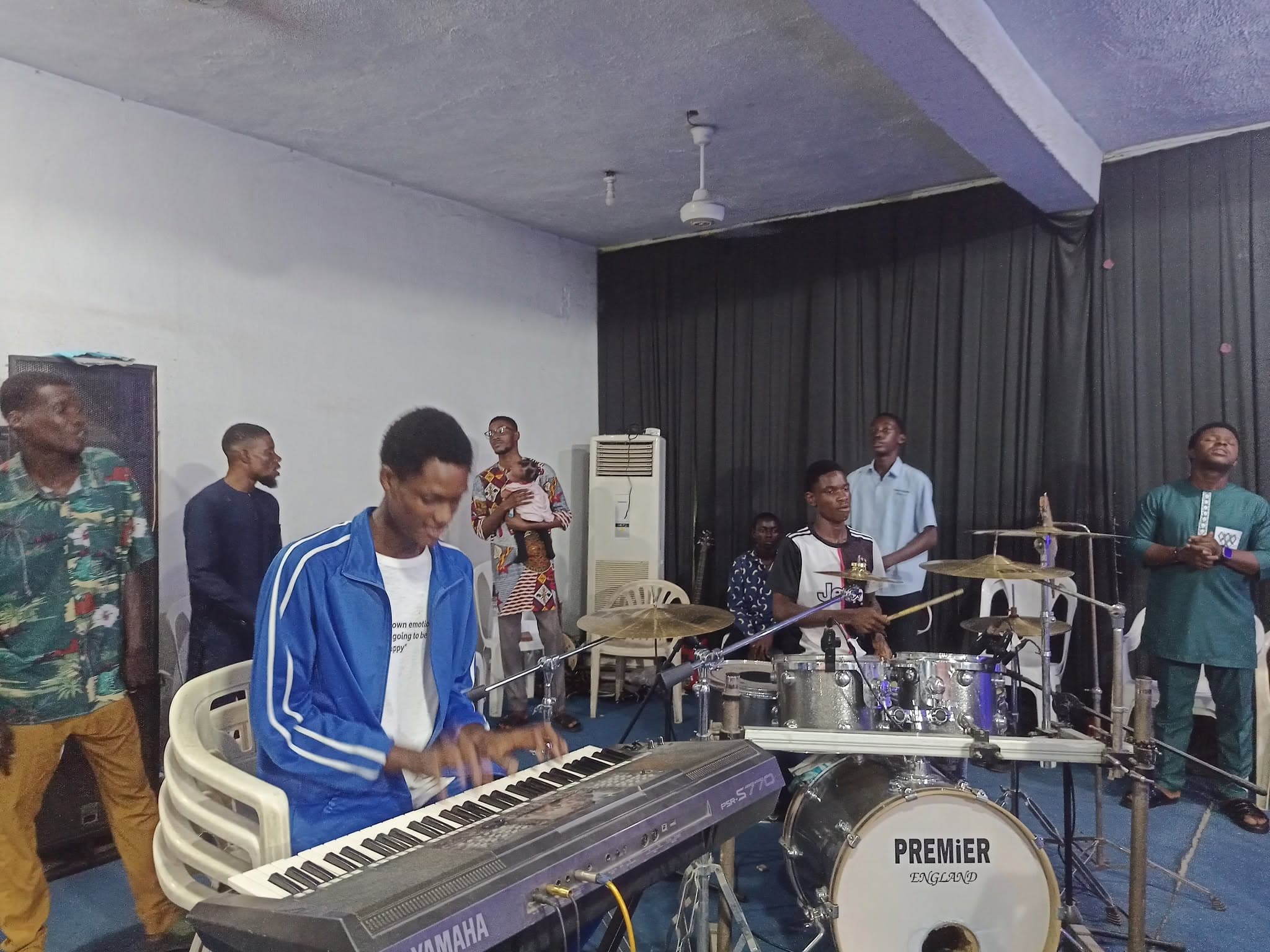 A young musician playing keyboard with the music team