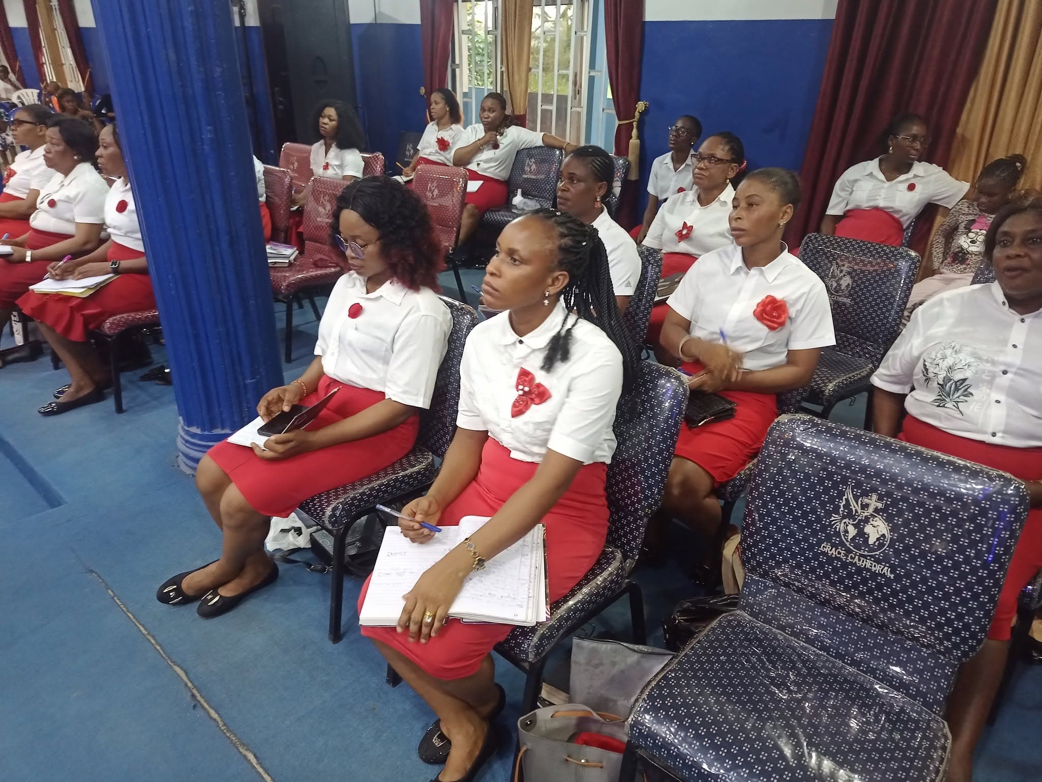 Ushers in red and white seated during a service