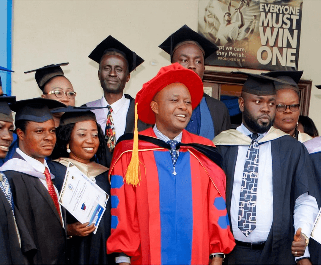 Redemption Bible College graduates with the General Overseer in doctoral regalia