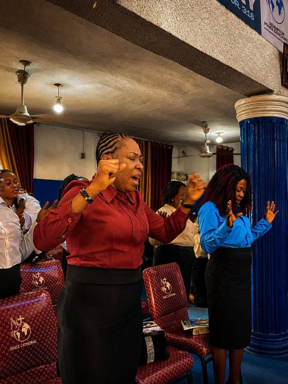 Members of the congregation standing in prayer