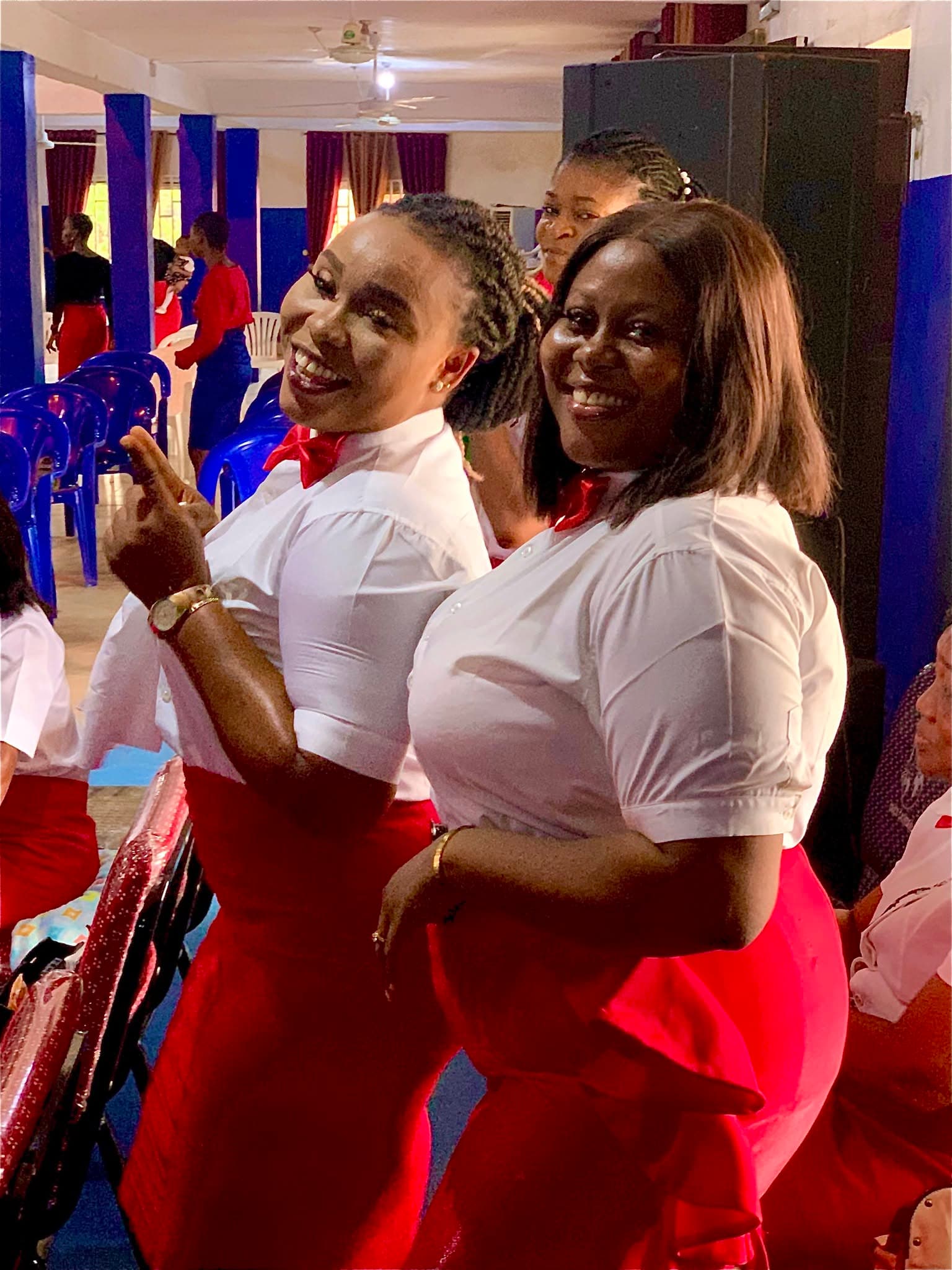 Two members of the welcome team smiling before a service