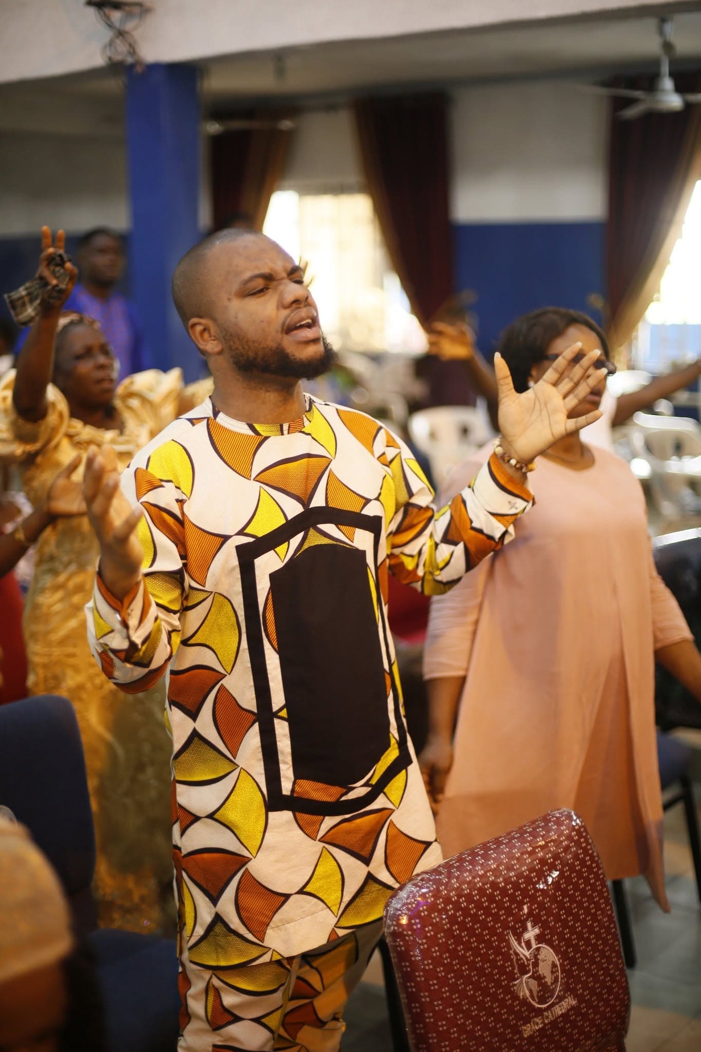 A young man worshipping with open hands during a service at Redemption Power Church