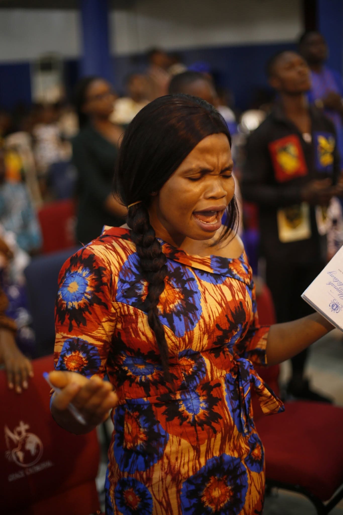 A woman singing during worship